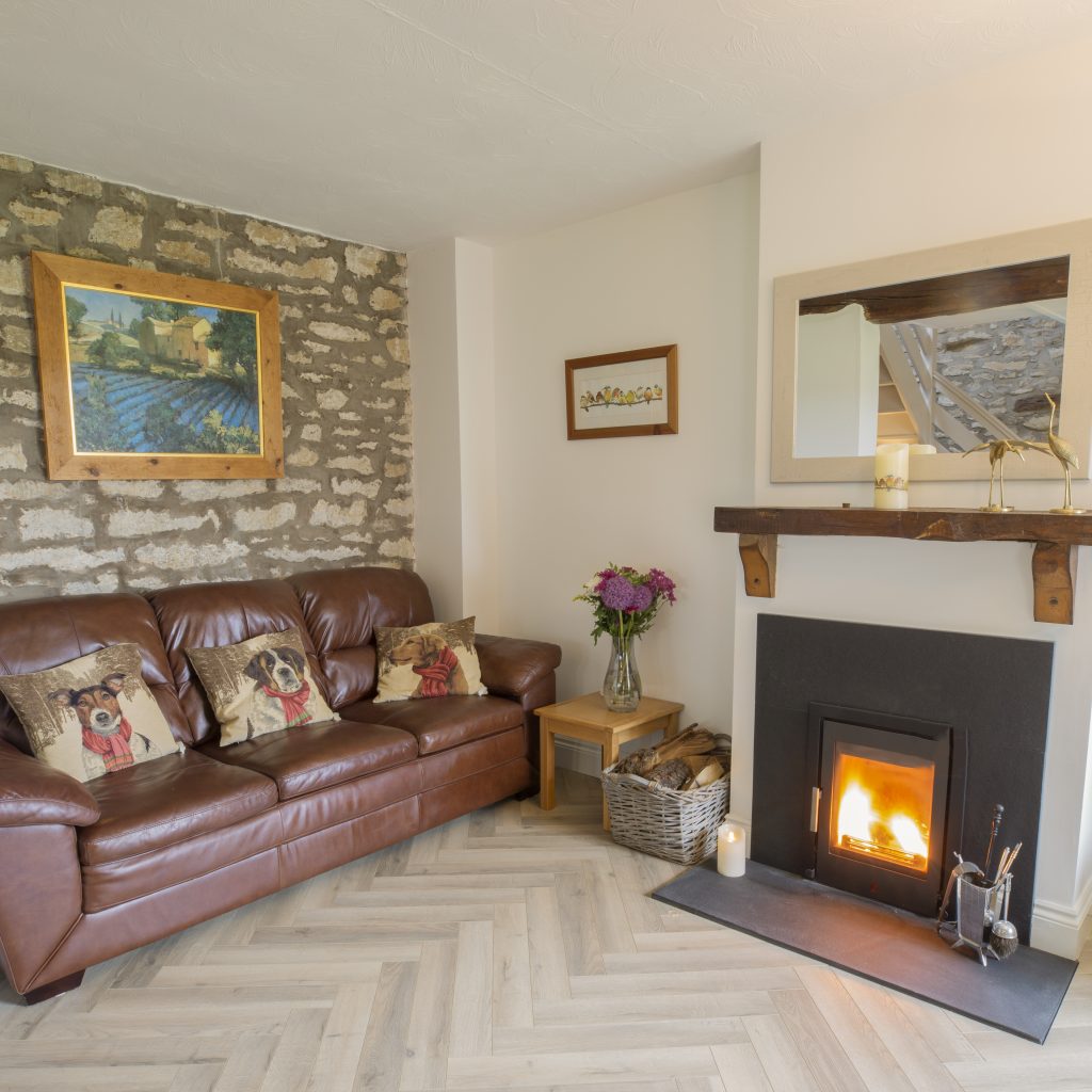 Living area with log burner and sofa